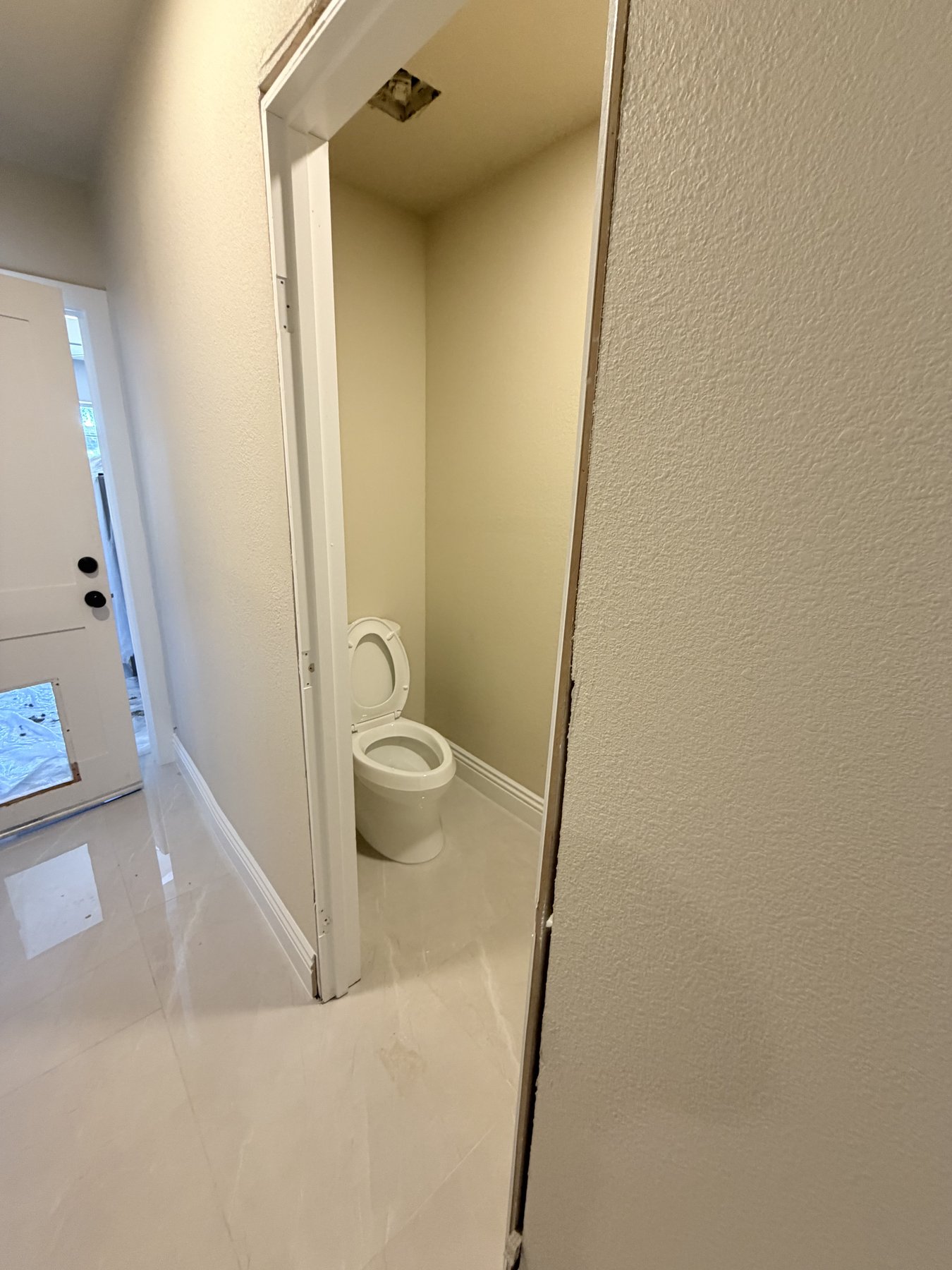 Finished bathroom with marble tile floor