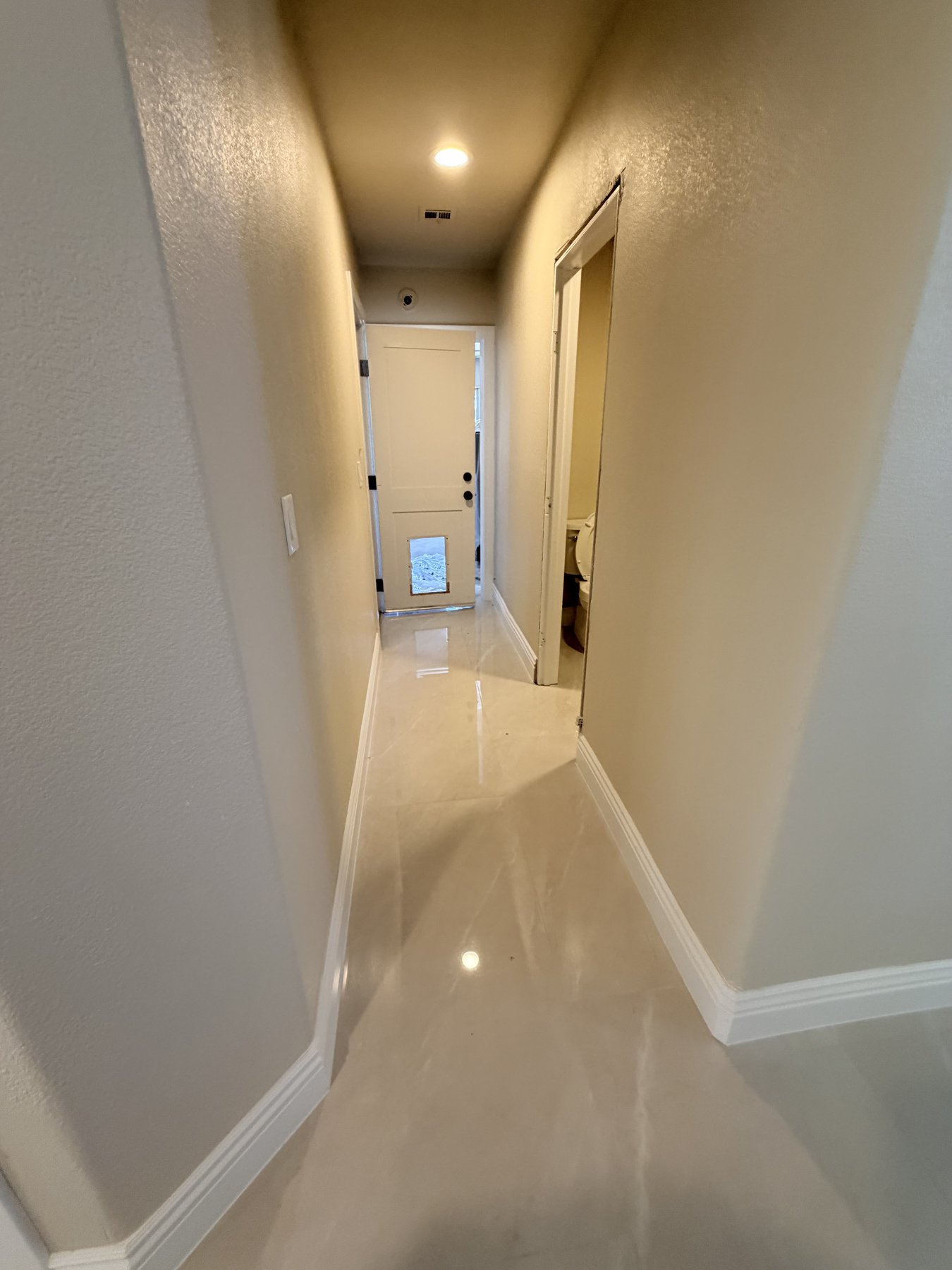 Finished tiled hallway with polished marble floor